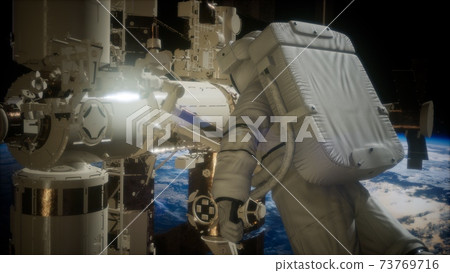 International Space Station and astronaut in outer space over the planet Earth International Space Station and astronaut in outer space over the planet Earth 73769716