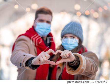 Heart shape sign made by man and woman hands Heart shape sign made by man and woman hands 73769947