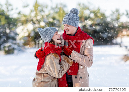 Millennial family spending day in park on snowy sunny day Millennial family spending day in park on snowy sunny day 73770205