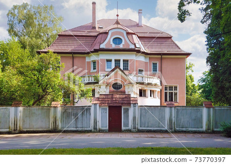 Old german mansion behind the fence in Kaliningrad Old german mansion behind the fence in Kaliningrad 73770397