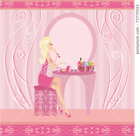 beautiful woman doing makeup at home 73770583