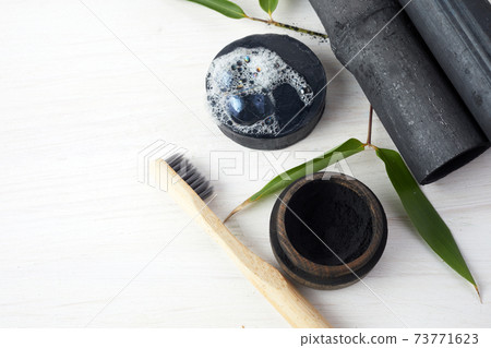 Bamboo charcoal eco friendly cosmetics products. Toothbrush and soap with skin cleansing 73771623