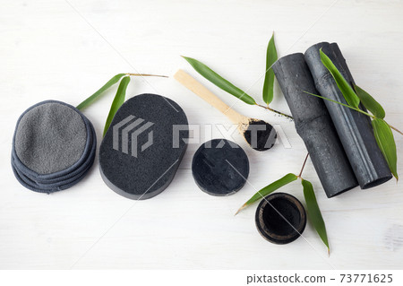 Bamboo charcoal eco friendly cosmetics products. Toothbrush and soap with skin cleansing 73771625