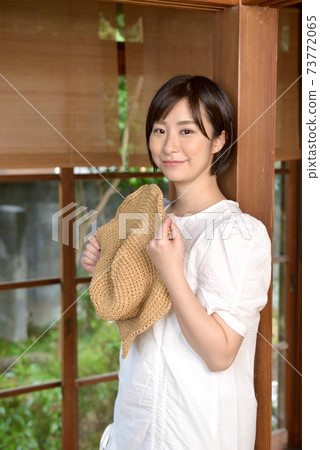 A pretty woman holding a straw hat in a Japanese-style room A pretty woman holding a straw hat in a Japanese-style room 73772065