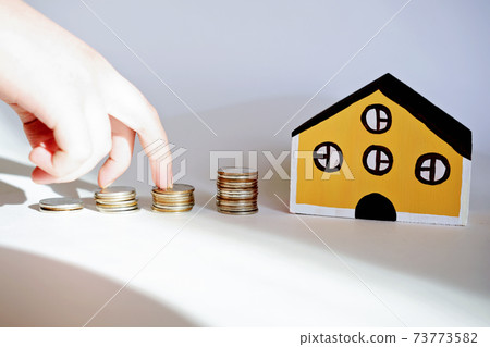 toy house and stacks coins toy house and stacks coins 73773582