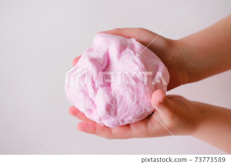 pink slime or handgum toy in kids hands. fluffy slime DIY project. 73773589