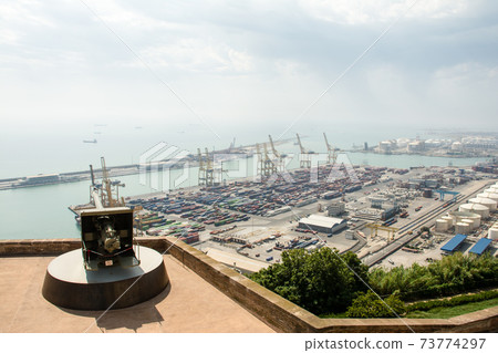 Barcelona harbor overlooking Montjuic castle on the hill Numerous containers, cranes, complexes and castle cannons Barcelona harbor overlooking Montjuic castle on the hill Numerous containers, cranes, complexes and castle cannons 73774297