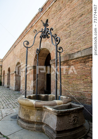 Brick buildings and wells in Montjuic Castle on the hills of Barcelona, Spain Brick buildings and wells in Montjuic Castle on the hills of Barcelona, Spain 73774407
