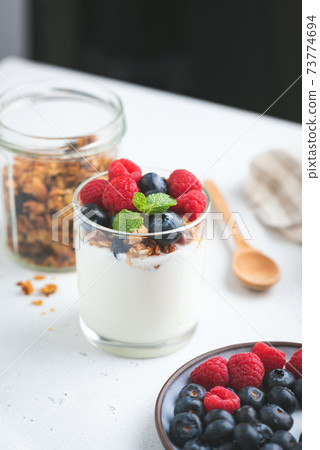 Yogurt with granola and berries in jar 73774694
