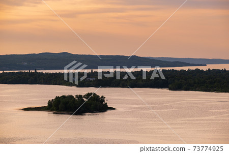 Dnipro river summer evening view from Taras Hill or Chernecha Hora (Monk Hill - important landmark of the Taras Shevchenko National Preserve, Kaniv, Cherkasy Region, Ukraine. Dnipro river summer evening view from Taras Hill or Chernecha Hora (Monk Hill - important landmark of the Taras Shevchenko National Preserve, Kaniv, Cherkasy Region, Ukraine. 73774925