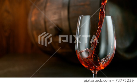 Pouring red wine into the glass 73775239