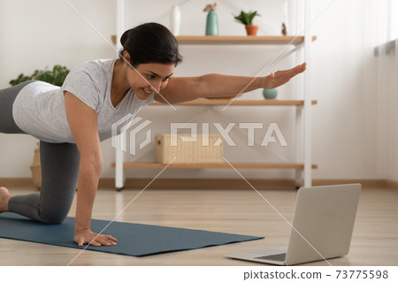 Young indian lady professional fitness trainer give yoga video lesson 73775598