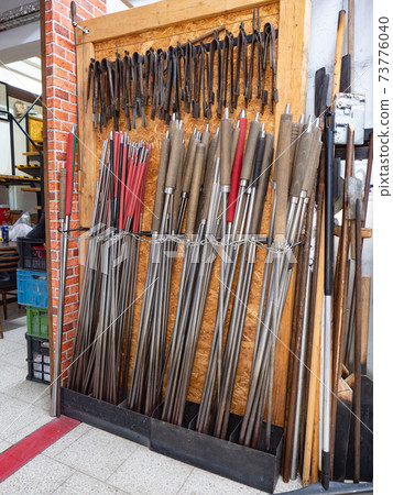 The rack with glassblowing pipes, pliers and shaping scissors. 73776040
