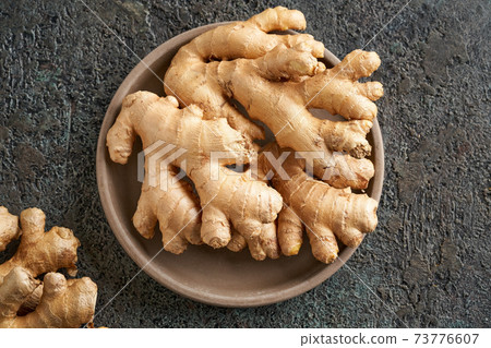 Fresh ginger root on a plate Fresh ginger root on a plate 73776607