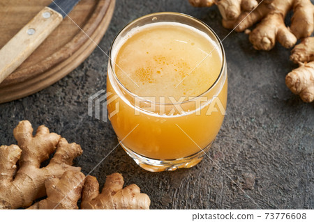 A glass of probiotic sparkling drink with ginger A glass of probiotic sparkling drink with ginger 73776608