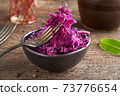 Red fermented cabbage on a fork in a bowl 73776654