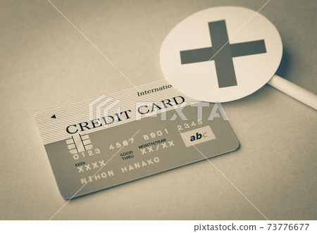 Credit card and x Credit card and hand x Credit card examination 73776677