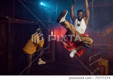 Two rappers joking, performing in cool studio 73777274