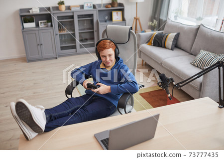 Red Haired Boy Playing Video Games 73777435