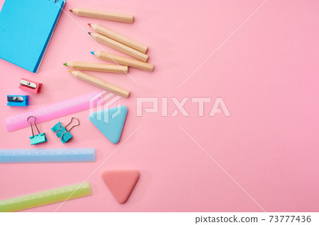 Stationery supplies closeup, pink background Stationery supplies closeup, pink background 73777436