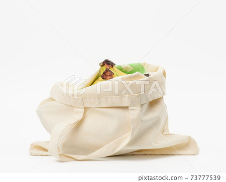 beige textile bag with fresh fruits on a white background 73777539