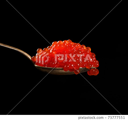 fresh grainy red chum salmon caviar in a metal spoon, delicious and healthy food 73777551