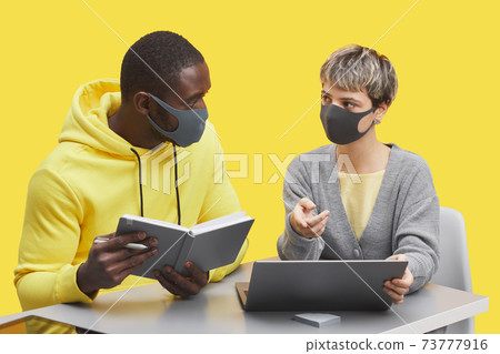 Creative Business Team Wearing Masks on Yellow Creative Business Team Wearing Masks on Yellow 73777916