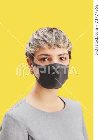 Businesswoman Wearing Mask on Yellow Businesswoman Wearing Mask on Yellow 73777958