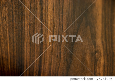 Dark brown woodgrain background material 73781926