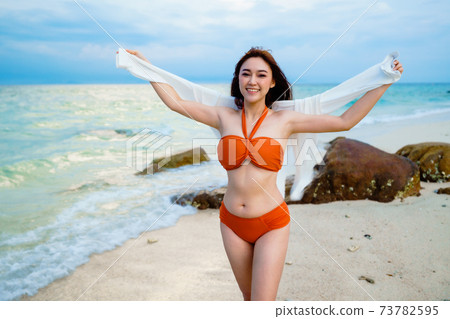 happy woman in the sea beach at Koh MunNork Island, Rayong, Thailand. happy woman in the sea beach at Koh MunNork Island, Rayong, Thailand. 73782595