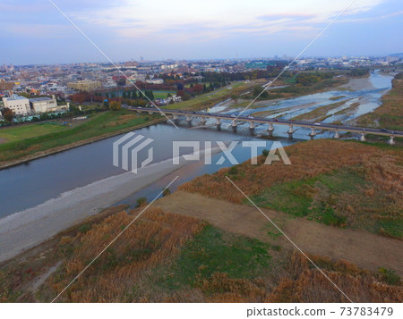 "Hino Bridge" seen from the right bank of the Tama River-Aerial view with a drone (Hino City, Tokyo) 73783479