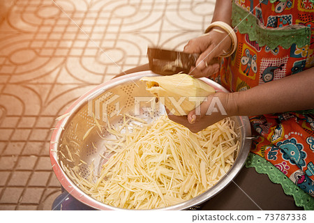 People slice raw papaya for cooking papaya salad. People slice raw papaya for cooking papaya salad. 73787338