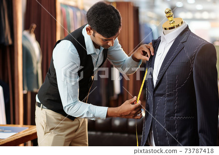 Tailor measuring bespoke jacket Tailor measuring bespoke jacket 73787418