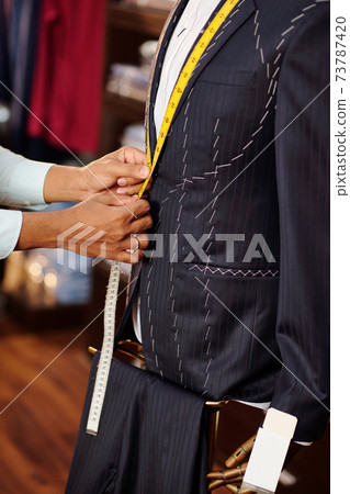 Tailor measuring jacket lapel Tailor measuring jacket lapel 73787420