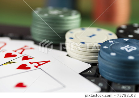 Game cards of the same suit against the background of casino chips Game cards of the same suit against the background of casino chips 73788108