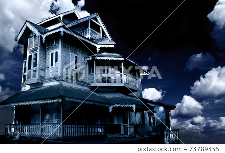 Haunted house. Old abandoned house on night sky background 73789355