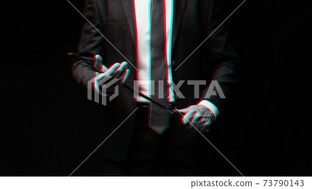 Male dominant businessman in a suit holding a leather whip Flogger for domination Male dominant businessman in a suit holding a leather whip Flogger for domination 73790143