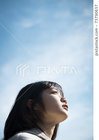 Emotional portrait of blue sky and women 73790637