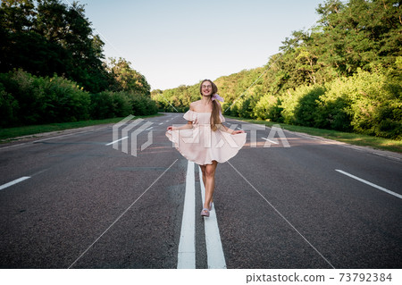 New way, new start, New year resolution, challenge, choice or change concept. Young Woman walking on the summer road with tree around New way, new start, New year resolution, challenge, choice or change concept. Young Woman walking on the summer road with tree around 73792384
