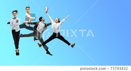 Happy office workers jumping and dancing in casual clothes or suit on gradient neon fluid background. Flyer with copyspace Happy office workers jumping and dancing in casual clothes or suit on gradient neon fluid background. Flyer with copyspace 73793832