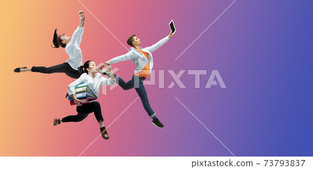 Happy office workers jumping and dancing in casual clothes or suit on gradient neon fluid background. Flyer with copyspace Happy office workers jumping and dancing in casual clothes or suit on gradient neon fluid background. Flyer with copyspace 73793837