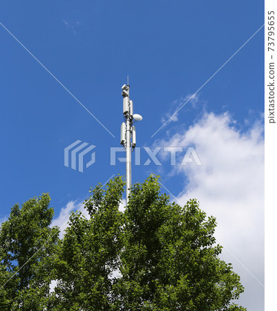 communication antennas, radio telephone mobile phone antennas on sky background 73795655