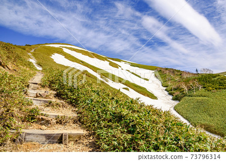 Spring Tairapyoyama mountain trail and snowy valley 73796314