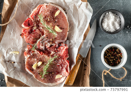 Raw pork steaks. 73797991