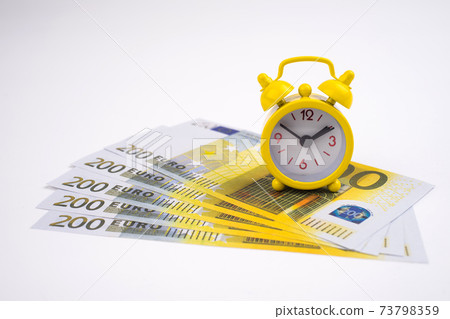 Retro styled alarm clock euro cash isolated on white. Retro styled alarm clock euro cash isolated on white. 73798359