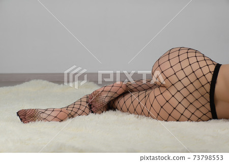 Fine female legs in pantyhose in a fishnet 73798553