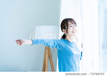 A woman basking in the morning sun 73798707