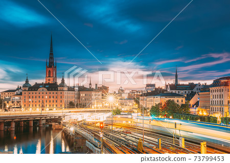 Stockholm, Sweden. Scenic View Of Stockholm Skyline At Summer Sunset. Riddarholm Church And Subway Railway With Train In Blurred Motion Stockholm, Sweden. Scenic View Of Stockholm Skyline At Summer Sunset. Riddarholm Church And Subway Railway With Train In Blurred Motion 73799453