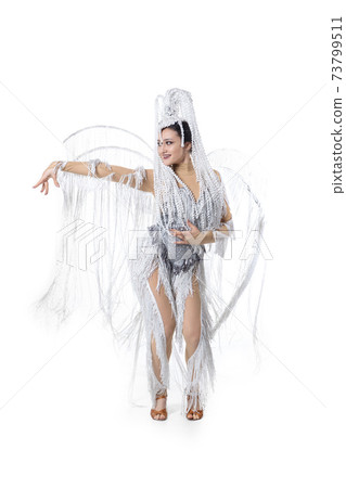 Beautiful young woman in carnival, stylish masquerade costume with feathers dancing on white studio background. Concept of holidays celebration, festive time, fashion Beautiful young woman in carnival, stylish masquerade costume with feathers dancing on white studio background. Concept of holidays celebration, festive time, fashion 73799511
