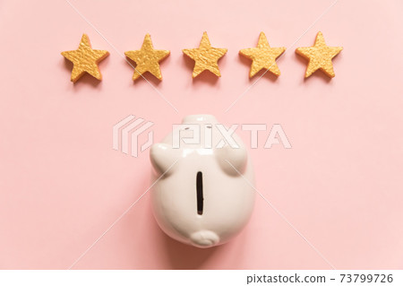 Simply minimal design piggy bank 5 gold stars isolated on pink background. Bank rating. Saving investment budget business retirement financial money banking concept. Flat lay top view copy space. Simply minimal design piggy bank 5 gold stars isolated on pink background. Bank rating. Saving investment budget business retirement financial money banking concept. Flat lay top view copy space. 73799726